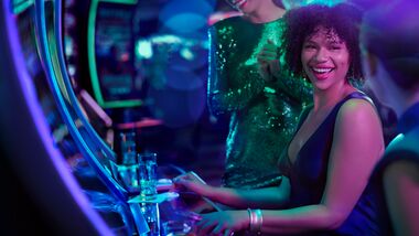 Women at a slot machine laughing
